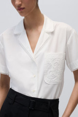 Profile view of model wearing the Oroton Lace Trim Blouse in White and 100% Cotton Poplin for Women . IP:6