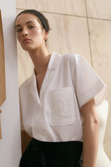 Profile view of model wearing the Oroton Lace Trim Blouse in White and 100% Cotton Poplin for Women . IP:2