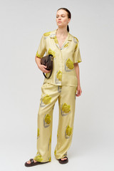 Profile view of model wearing the Oroton Linear Tulip Camp Shirt in Fennel and 100% silk for Women