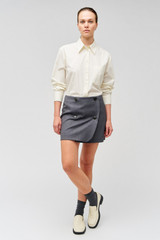 Profile view of model wearing the Oroton Poplin Long Sleeve Shirt in Cream and 100% cotton for Women
