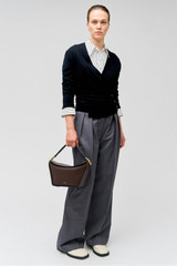 Profile view of model wearing the Oroton Wrap Cardigan in Black and 100% merino wool for Women