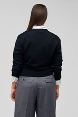 Profile view of model wearing the Oroton Wrap Cardigan in Black and 100% merino wool for Women