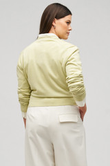 Profile view of model wearing the Oroton Wrap Cardigan in Fennel and 100% merino wool for Women