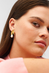 Profile view of model wearing the Oroton Alma Studs in Worn Gold/Pearl and Brass for Women . IP:2