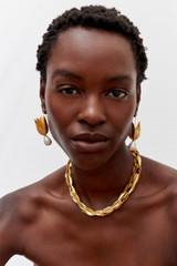 Profile view of model wearing the Oroton Alma Hook Earrings in Worn Gold/Pearl and Brass for Women . IP:3