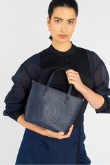 Profile view of model wearing the Oroton Polly Small Tote in Dark Navy and Pebble Leather for Women . IP:3