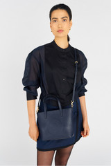Profile view of model wearing the Oroton Polly Small Tote in Dark Navy and Pebble Leather for Women . IP:4