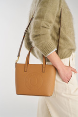 Profile view of model wearing the Oroton Polly Small Tote in Tan and Pebble Leather for Women