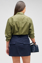 Profile view of model wearing the Oroton Mini Trouser Skirt in North Sea and 98%  wool, 2% elastane for Women