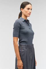 Profile view of model wearing the Oroton Stitch Rib Polo in Charcoal Marle and 100% wool for Women