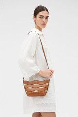Profile view of model wearing the Oroton Leigh Ric Rac Crossbody in Amber and Smooth leather for Women . IP:2