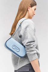 Profile view of model wearing the Oroton Oro Baguette in Denim and Smooth leather for Women