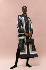Profile view of model wearing the Oroton Bandana Print Dress in Black and 100% silk for Women . IP:6