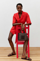 Profile view of model wearing the Oroton Fringe Detail Dress in Poppy and 100% cotton for Women .