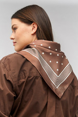 Profile view of model wearing the Oroton Bandana Silk Scarf in Chocolate and 100% silk for Women . IP:2