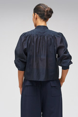 Profile view of model wearing the Oroton 3D Starburst Flower Top in North Sea and 68% COTTON 32% SILK for Women . IP:9