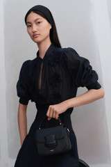 Profile view of model wearing the Oroton 3D Starburst Flower Top in North Sea and 68% COTTON 32% SILK for Women . IP:6