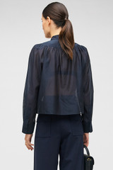 Profile view of model wearing the Oroton 3D Starburst Flower Top in North Sea and 68% COTTON 32% SILK for Women . IP:4