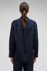 Profile view of model wearing the Oroton Pinstripe Overshirt in North Sea and 95% WOOL 5% ELASTANE for Women . IP:6
