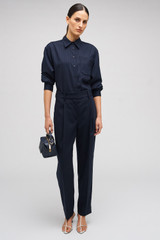 Profile view of model wearing the Oroton Tapered Pinstripe Pant in North Sea and 95% WOOL 5% ELASTANE for Women . IP:3