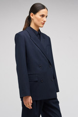 Profile view of model wearing the Oroton Pinstripe Blazer in North Sea and 95% WOOL 5% ELASTANE for Women . IP:4