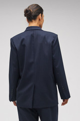 Profile view of model wearing the Oroton Pinstripe Blazer in North Sea and 95% WOOL 5% ELASTANE for Women . IP:9
