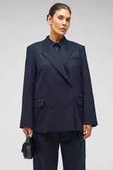 Profile view of model wearing the Oroton Pinstripe Blazer in North Sea and 95% WOOL 5% ELASTANE for Women . IP:8