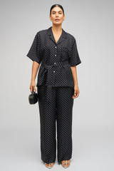 Profile view of model wearing the Oroton Long Belted Camp Shirt in Black/Cream and 100% Silk for Women .