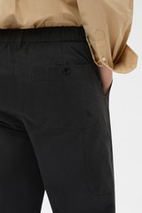 Profile view of model wearing the Oroton Arlo Carpenter Chino in Washed Black and 100% cotton fabric for Women . IP:5