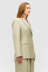 Profile view of model wearing the Oroton Wrap Blazer in Laurel and 58% Viscose 42% Linen for Women . IP:4