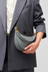 Profile view of model wearing the Oroton Florence Small Shoulder Bag in Grey Flannel and Smooth leather for Women . IP:4