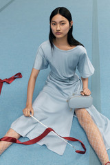 Profile view of model wearing the Oroton Drape Front Dress in Denim Blue and 92% Silk 8% Spandex for Women . IP:6