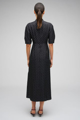 Profile view of model wearing the Oroton Spot Print Day Dress in Black and 100% Silk for Women . IP:5