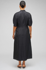Profile view of model wearing the Oroton Spot Print Day Dress in Black and 100% Silk for Women . IP:11