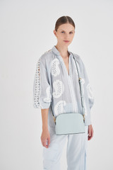Profile view of model wearing the Oroton Inez Slim Crossbody in Duck Egg and Shiny soft saffiano leather for Women . IP:2