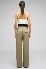 Profile view of model wearing the Oroton Cotton Pleat Pant in Silt and 100% cotton material for Women
