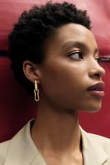 Profile view of model wearing the Oroton Livia Enamel Drop Earring in Worn Gold/Antique White and  for Women . IP:3
