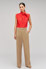 Profile view of model wearing the Oroton Cotton Pleat Pant in Camel and 100% cotton material for Women