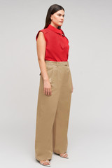 Profile view of model wearing the Oroton Cotton Pleat Pant in Camel and 100% cotton material for Women