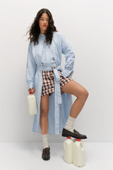Profile view of model wearing the Oroton Yarn Dyed Stripe Dress in Denim Blue and Made from 100% cotton  for Women