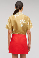 Profile view of model wearing the Oroton Pocket Detail Mini Skirt in Poppy and 100% linen material for Women . IP:5