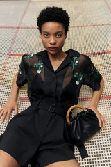 Profile view of model wearing the Oroton Rosebud Embroidery Camp Shirt in Black and 100% silk material for Women