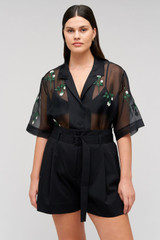 Profile view of model wearing the Oroton Rosebud Embroidery Camp Shirt in Black and 100% silk material for Women
