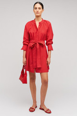 Profile view of model wearing the Oroton Lace Detail Smock Dress in Poppy and 100% cotton material for Women