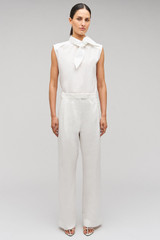 Profile view of model wearing the Oroton Cotton Pleat Pant in Cream and 100% cotton material for Women