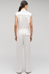 Profile view of model wearing the Oroton Cotton Pleat Pant in Cream and 100% cotton material for Women