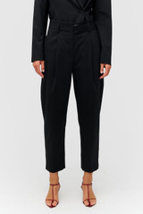 Profile view of model wearing the Oroton Tapered Pleat Pant in Black and 98% wool 2% elastane material for Women . IP:3