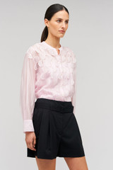 Profile view of model wearing the Oroton Scallop Lace Overshirt in Pink Rose and 85% Tencel 15% Polyester for Women