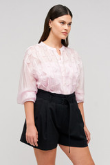 Profile view of model wearing the Oroton Scallop Lace Overshirt in Pink Rose and 85% Tencel 15% Polyester for Women