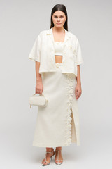 Profile view of model wearing the Oroton Rosebud Lace Camp Shirt in Soft Cream and 100% linen material for Women